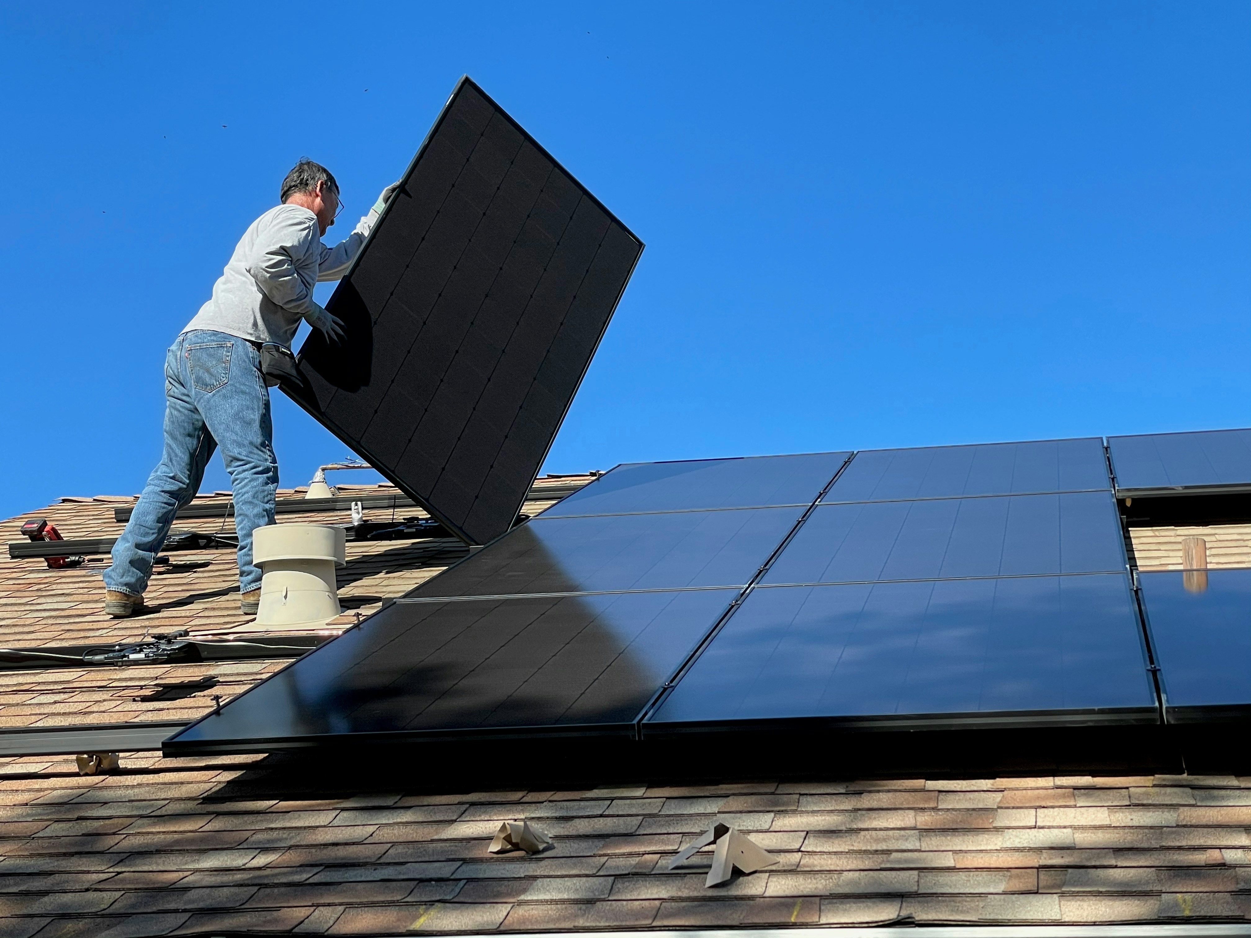 Technician inspecting solar inverters